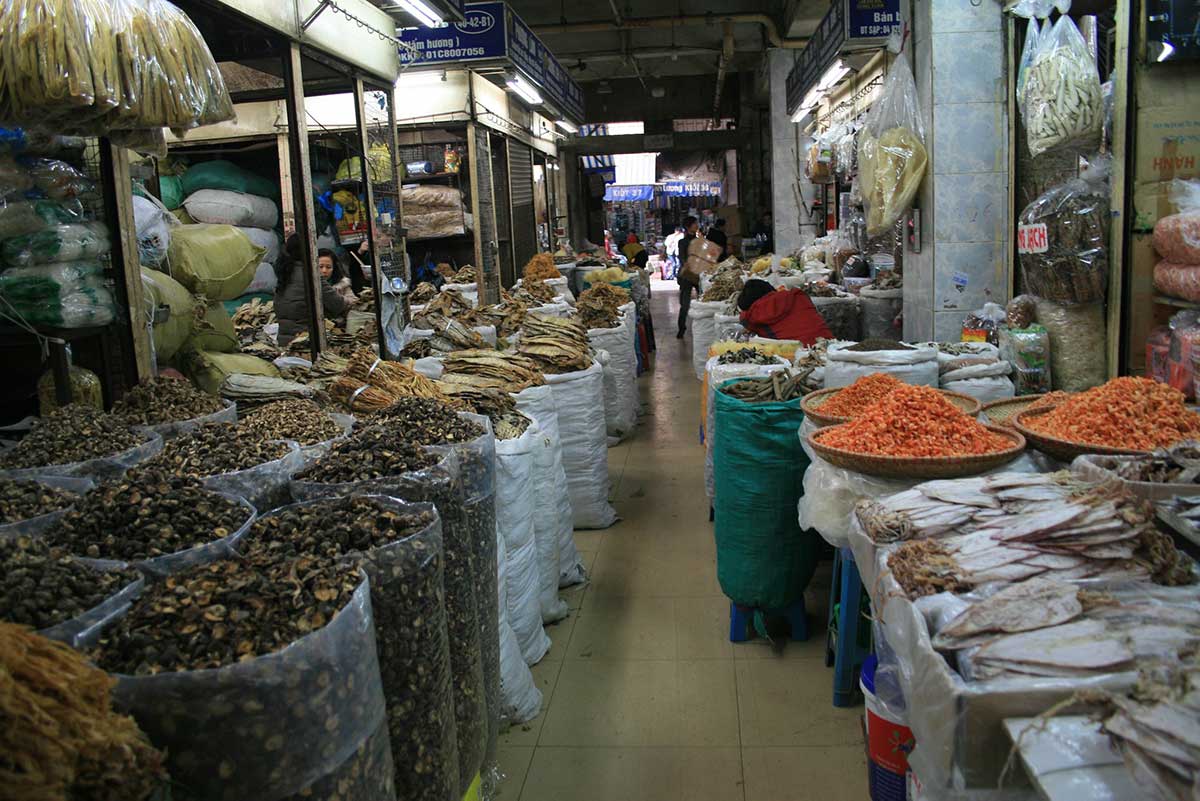 Vietnamese coffee beans and dried snacks for sale at Dong Xuan Market